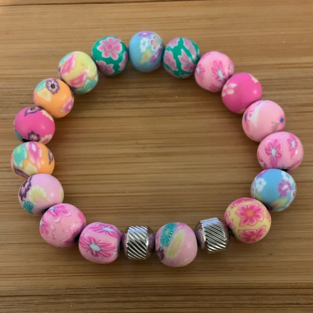 Multicolor pink bead stretch bracelet with stainless steel accents. Brand new